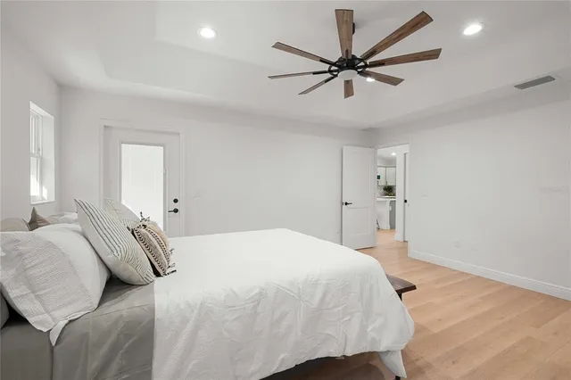 a bedroom with a bed and a ceiling fan