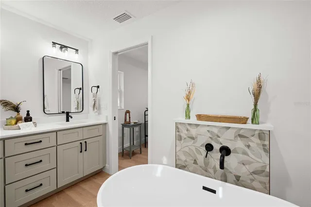a bathroom with a double vanity sink and mirror