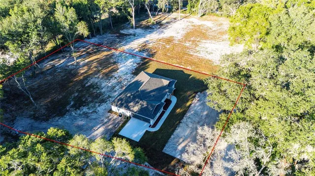 an aerial view of a house with a yard