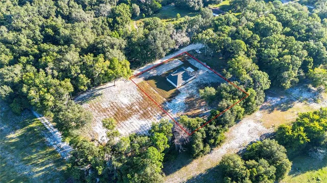 a front view of a house with a garden and yard