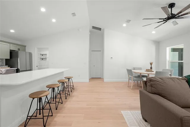 a living room with furniture a table and chairs