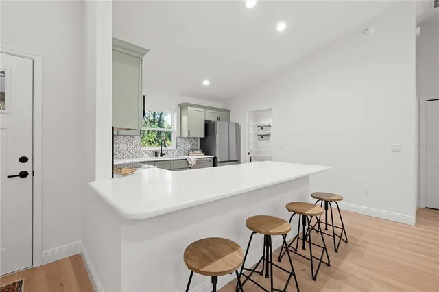 a dining room with furniture and wooden floor