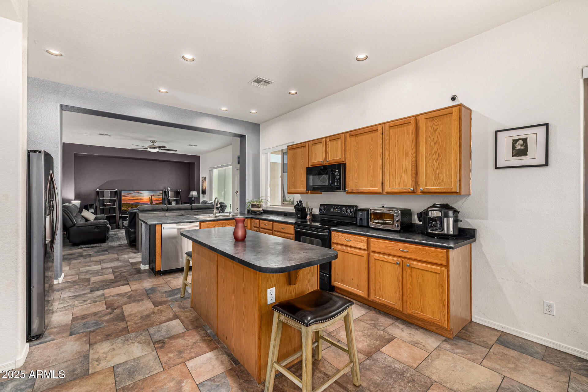 2026 North Rascon Loop Phoenix, AZ 85037 - Photo 12 of 38 a kitchen with granite countertop a sink stove top oven and cabinets