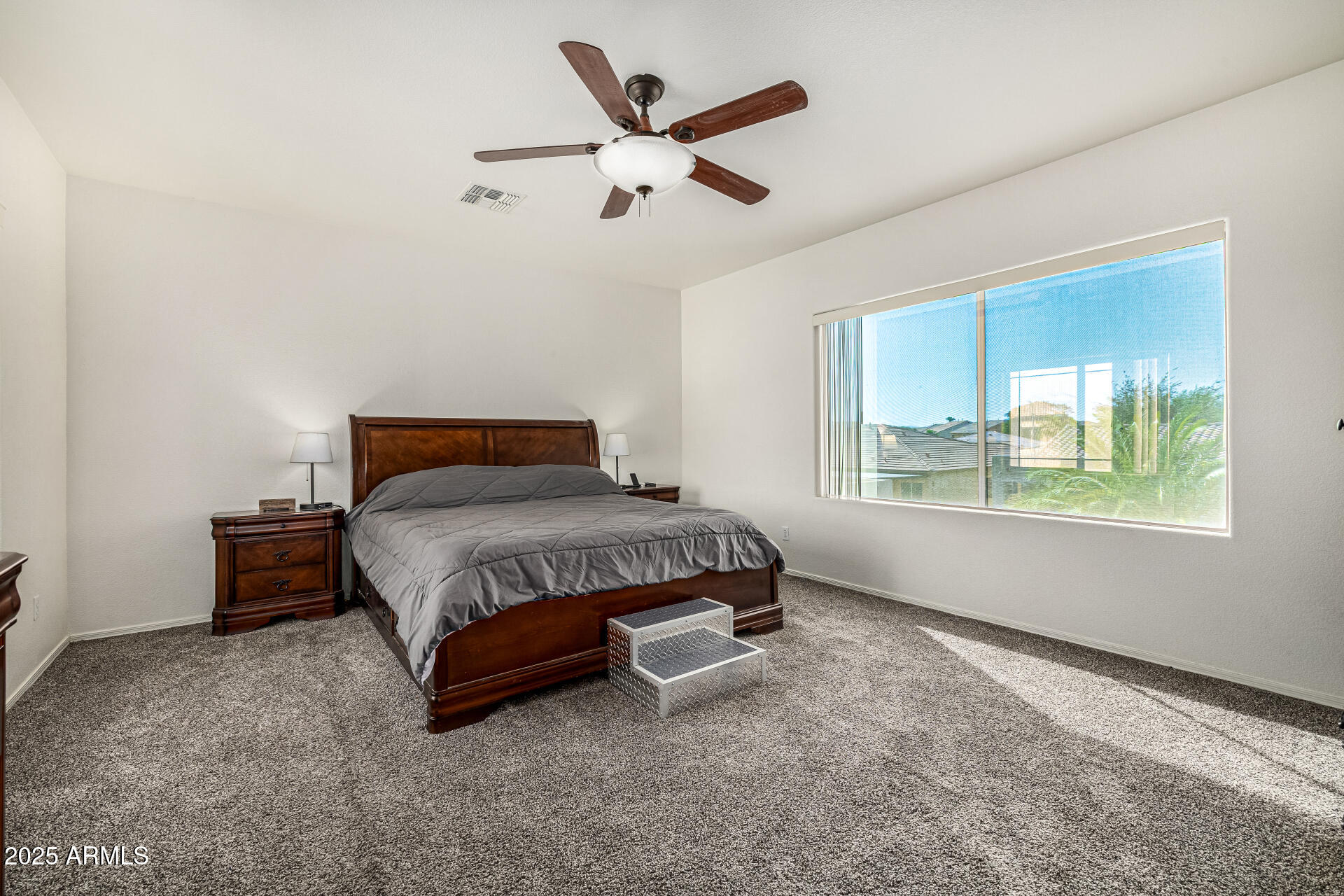 2026 North Rascon Loop Phoenix, AZ 85037 - Photo 14 of 38 a bedroom with a bed and window