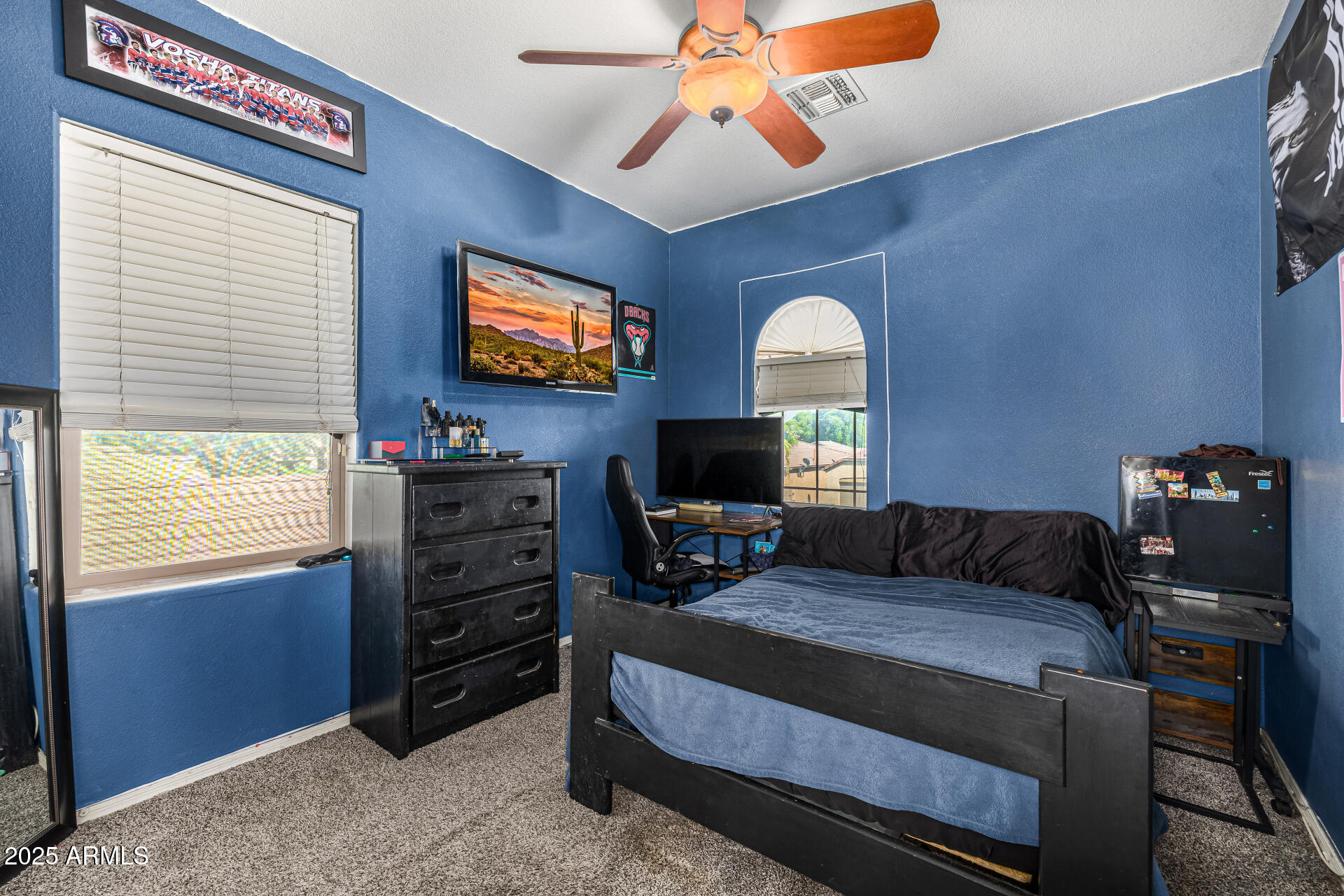 2026 North Rascon Loop Phoenix, AZ 85037 - Photo 18 of 38 a living room with furniture a flat screen tv and a window