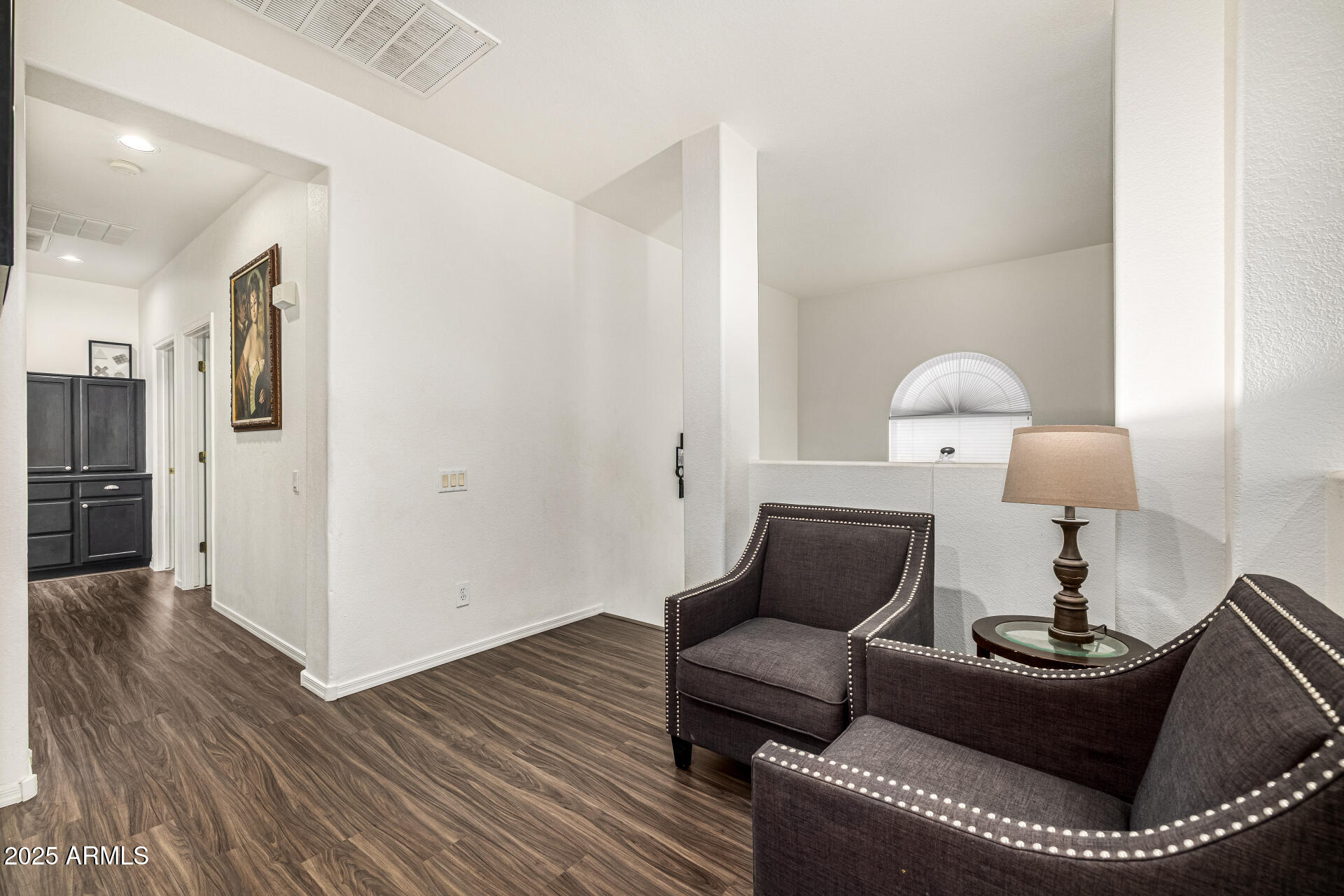 2026 North Rascon Loop Phoenix, AZ 85037 - Photo 21 of 38 a living room with furniture and a lamp