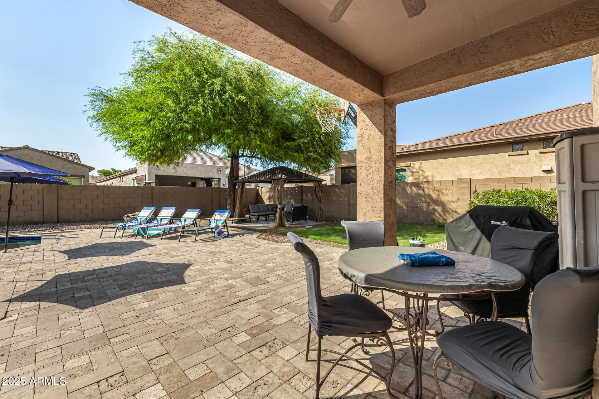2026 North Rascon Loop Phoenix, AZ 85037 - Photo 23 of 38 a view of a patio with a table chairs and a patio