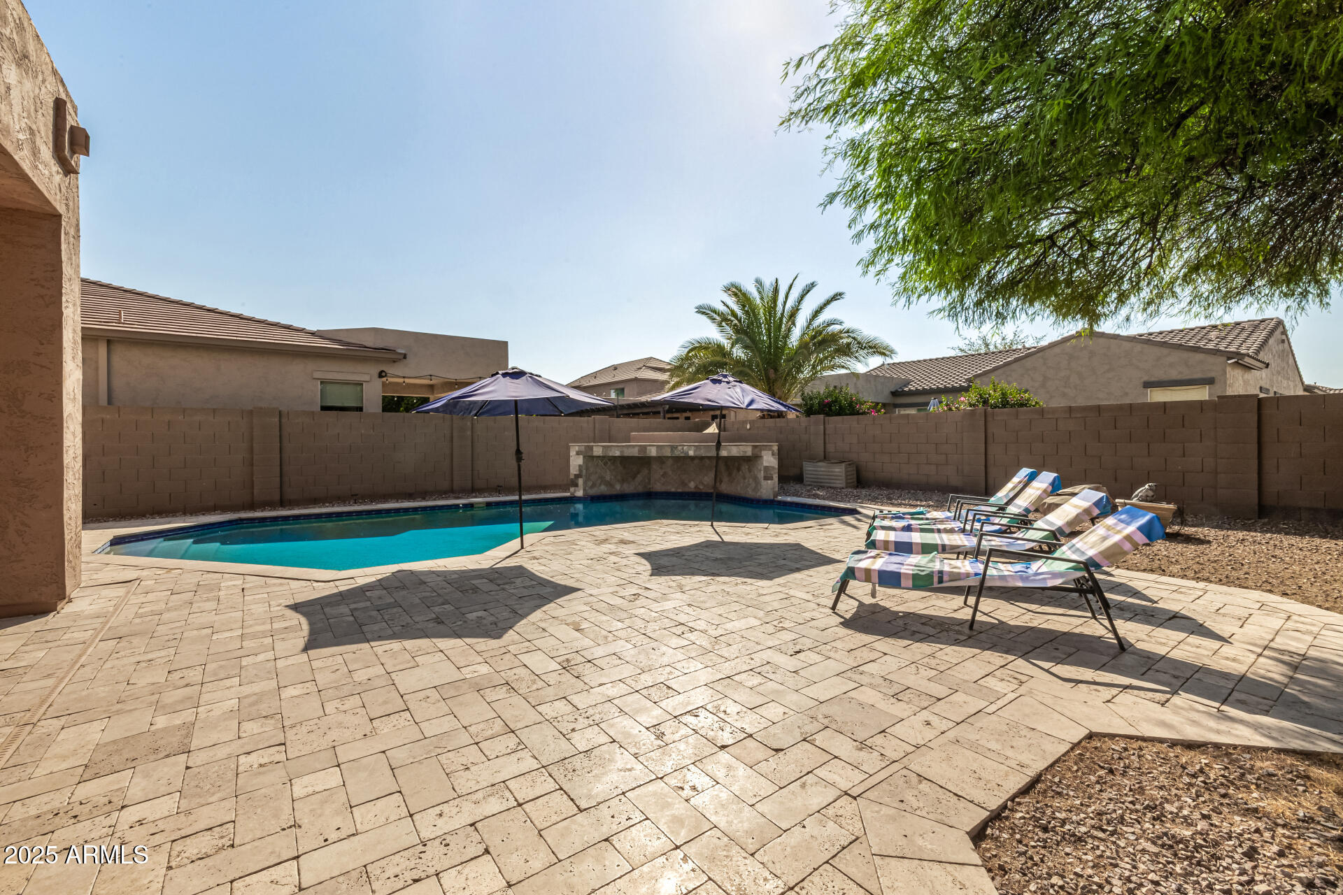 2026 North Rascon Loop Phoenix, AZ 85037 - Photo 24 of 38 a building outdoor space with patio furniture