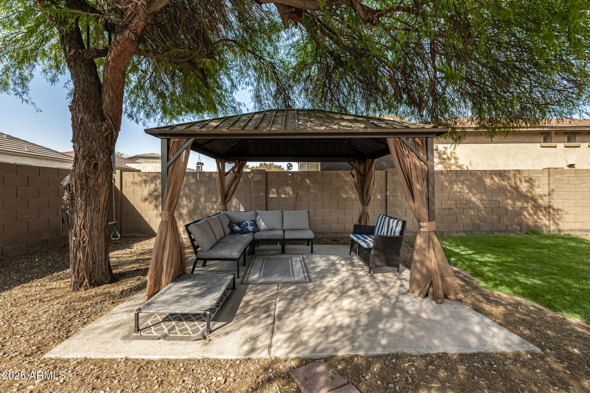 2026 North Rascon Loop Phoenix, AZ 85037 - Photo 26 of 38 a view of a yard with an outdoor seating