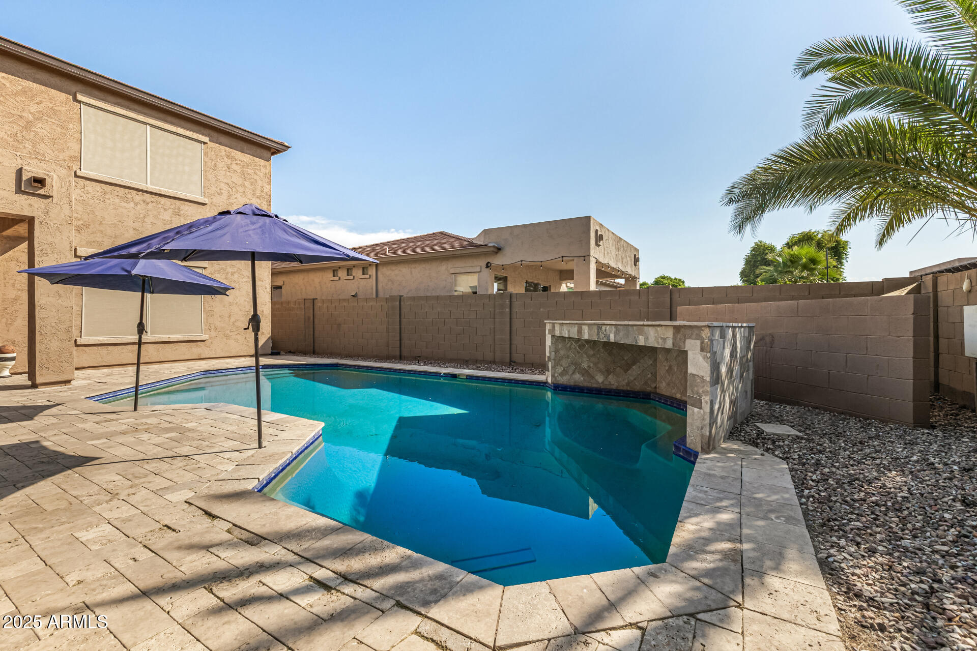 2026 North Rascon Loop Phoenix, AZ 85037 - Photo 29 of 38 a view of a patio with chairs under an umbrella