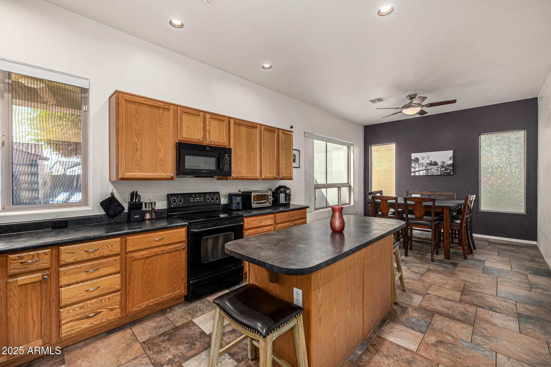 2026 North Rascon Loop Phoenix, AZ 85037 - Photo 3 of 38 a kitchen with sink refrigerator and stove