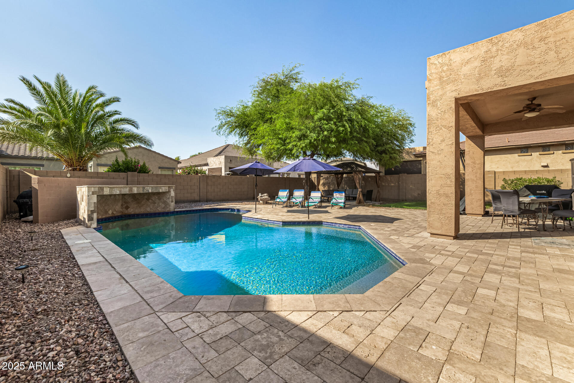 2026 North Rascon Loop Phoenix, AZ 85037 - Photo 31 of 38 a view of a swimming pool with a patio
