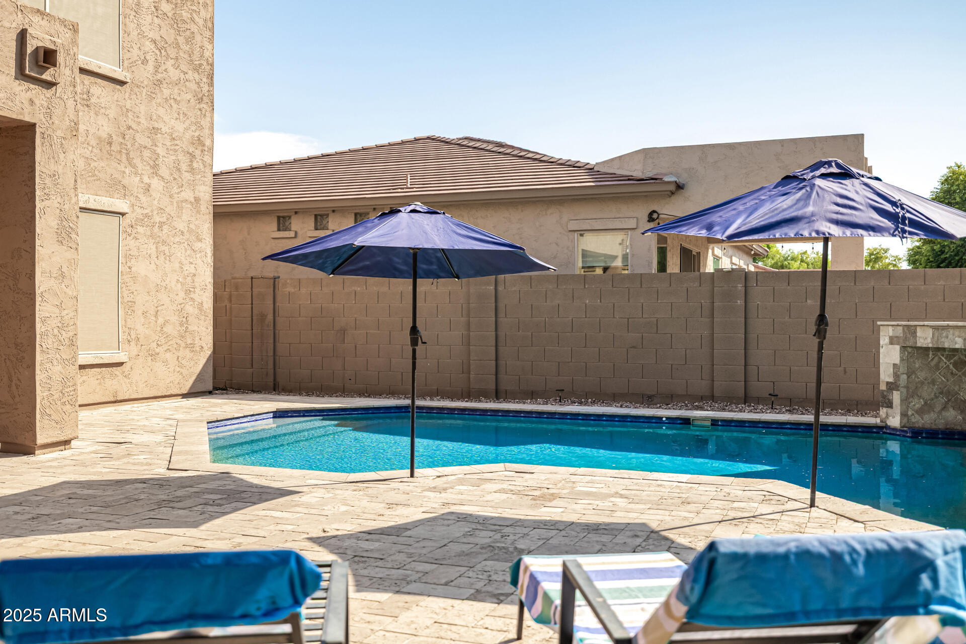 2026 North Rascon Loop Phoenix, AZ 85037 - Photo 32 of 38 a backyard of a house with table and chairs