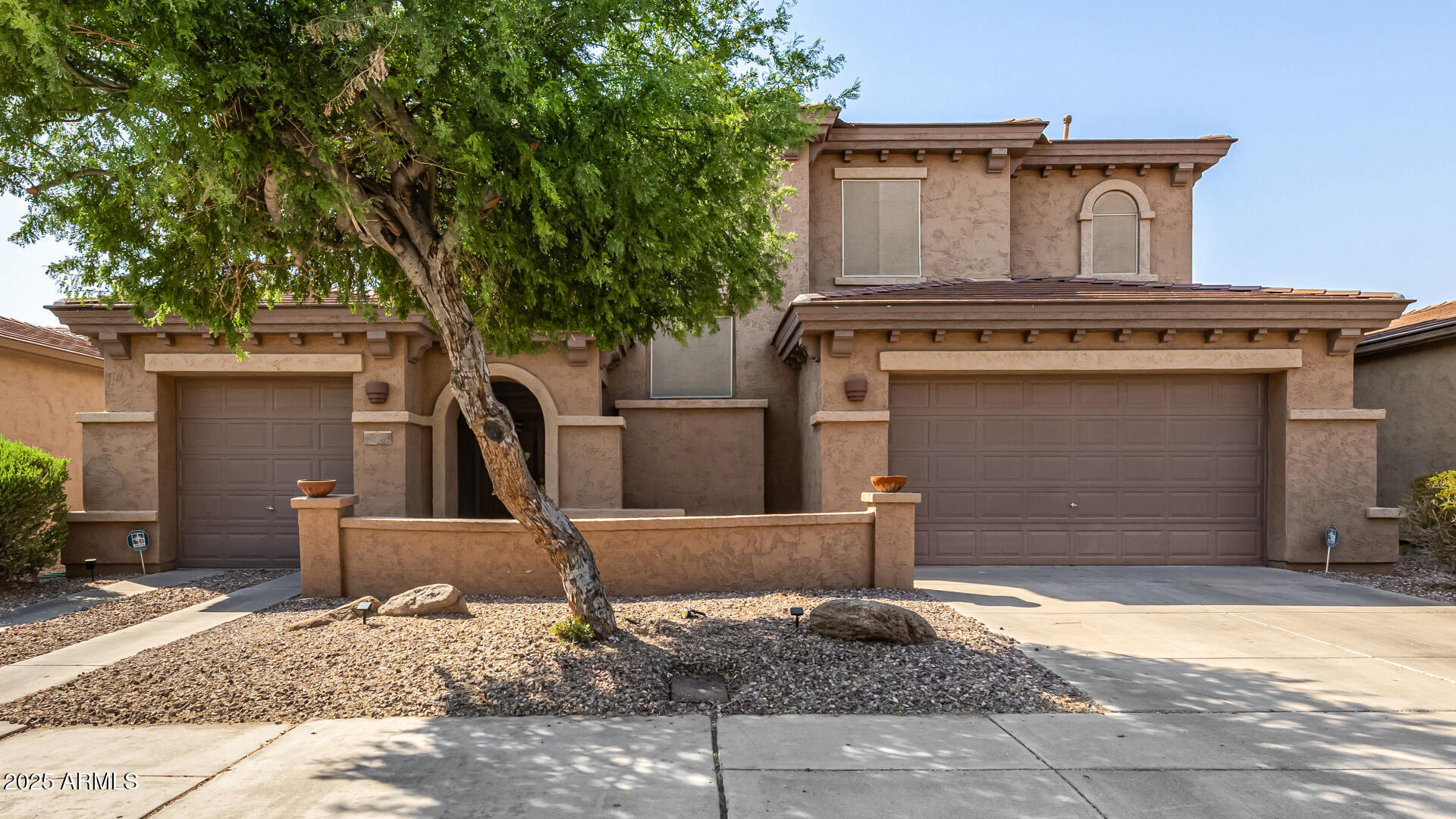 2026 North Rascon Loop Phoenix, AZ 85037 - Photo 33 of 38 a front view of a house with garden