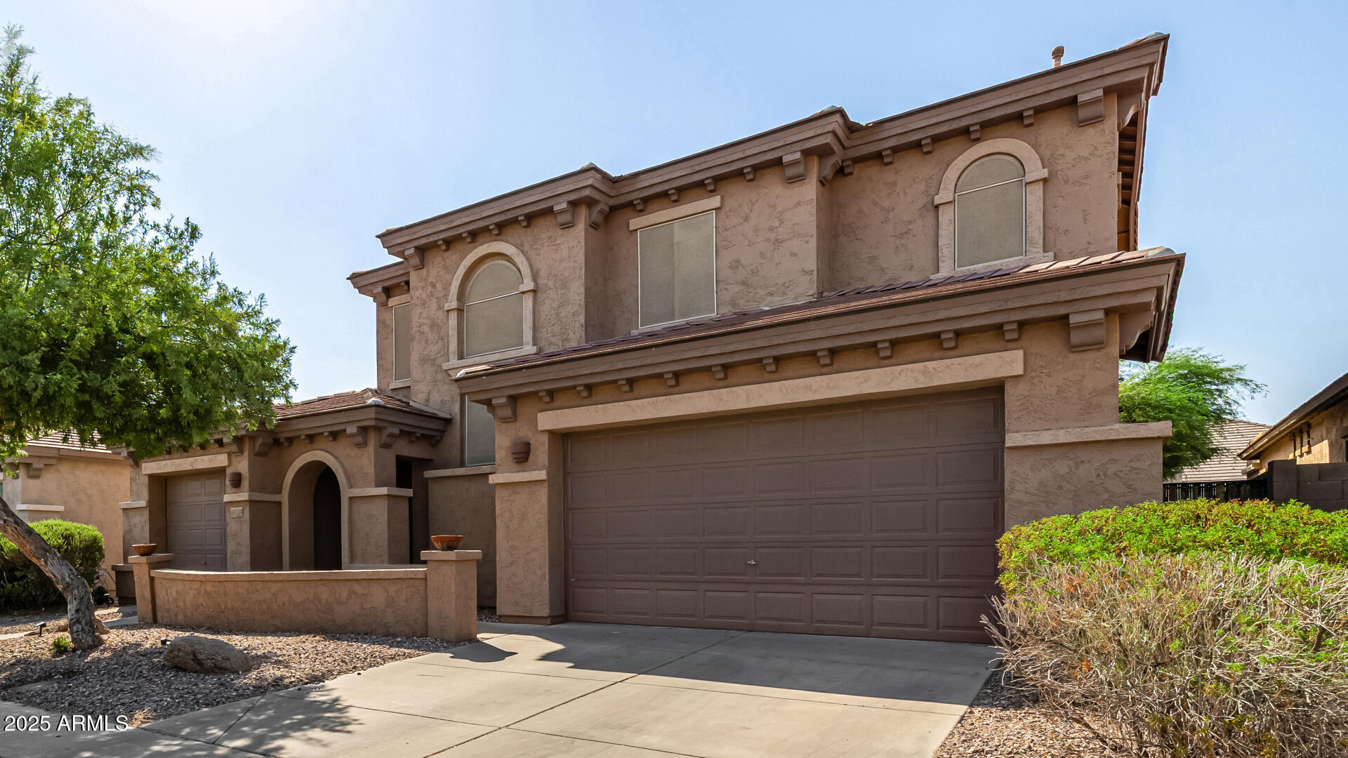 2026 North Rascon Loop Phoenix, AZ 85037 - Photo 34 of 38 a front view of a house with entryway