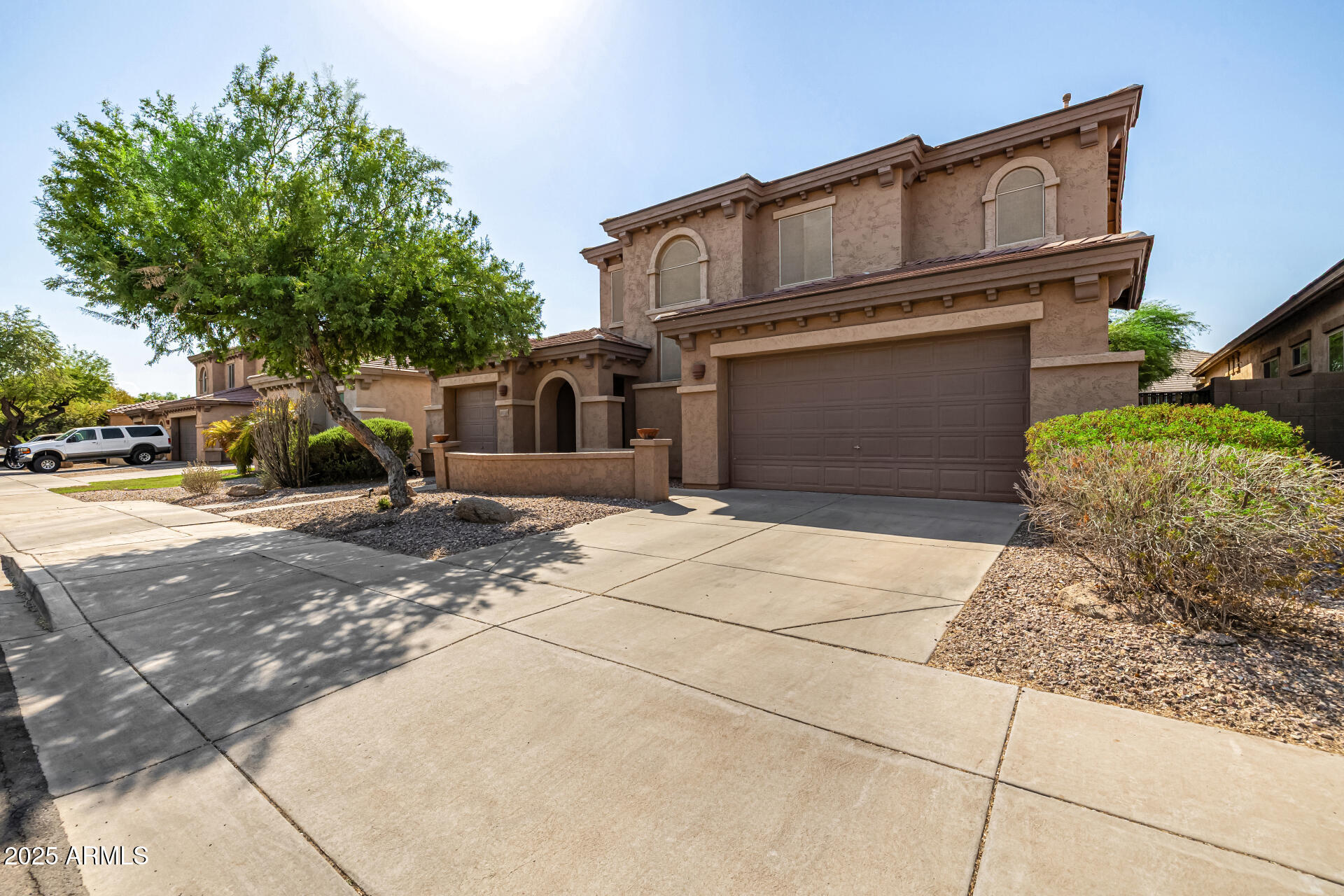 2026 North Rascon Loop Phoenix, AZ 85037 - Photo 36 of 38 a front view of a house with garden