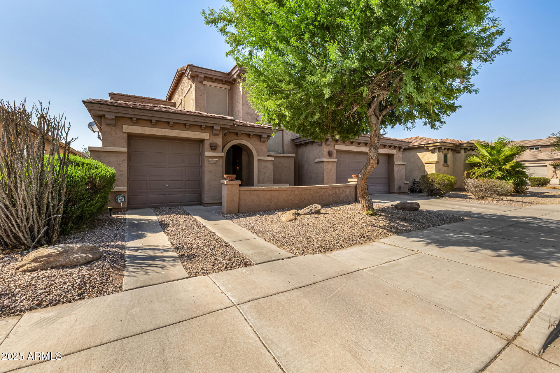 2026 North Rascon Loop Phoenix, AZ 85037 - Photo 37 of 38 a front view of a house with a yard