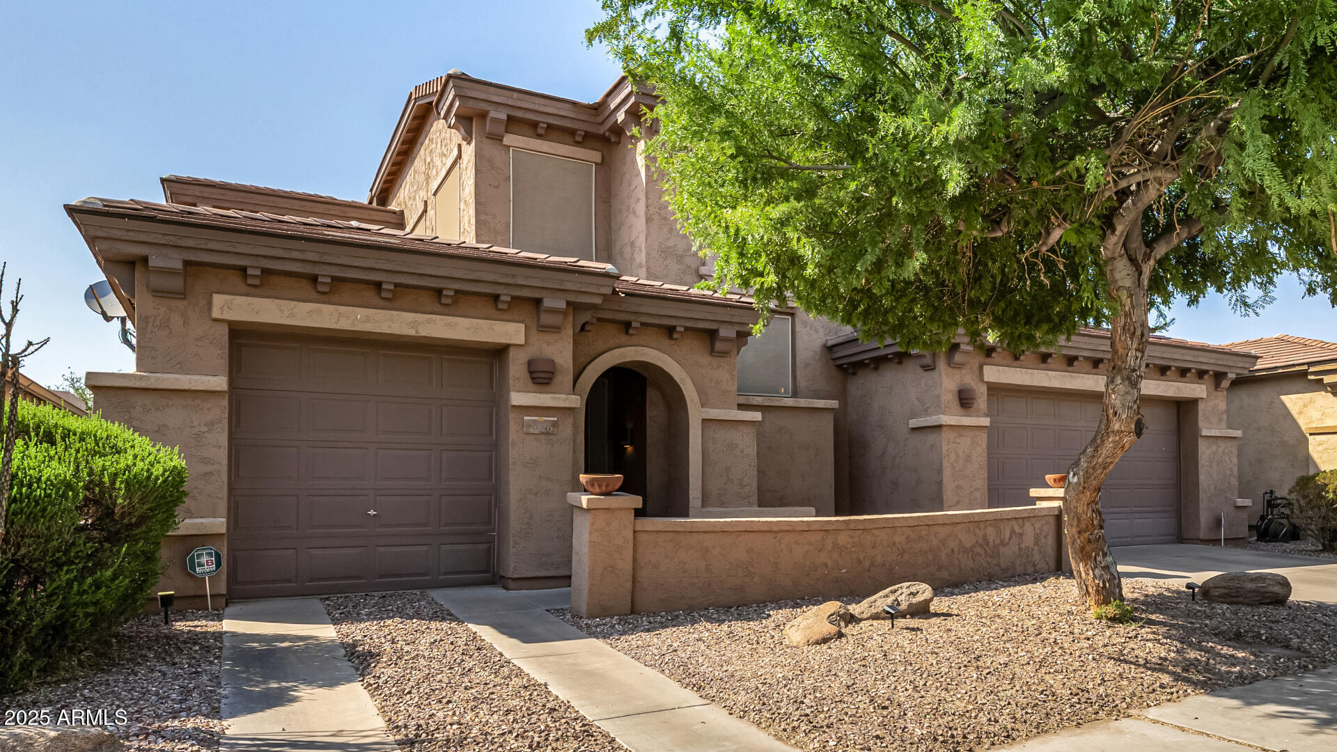 2026 North Rascon Loop Phoenix, AZ 85037 - Photo 38 of 38 a front view of a house with plants