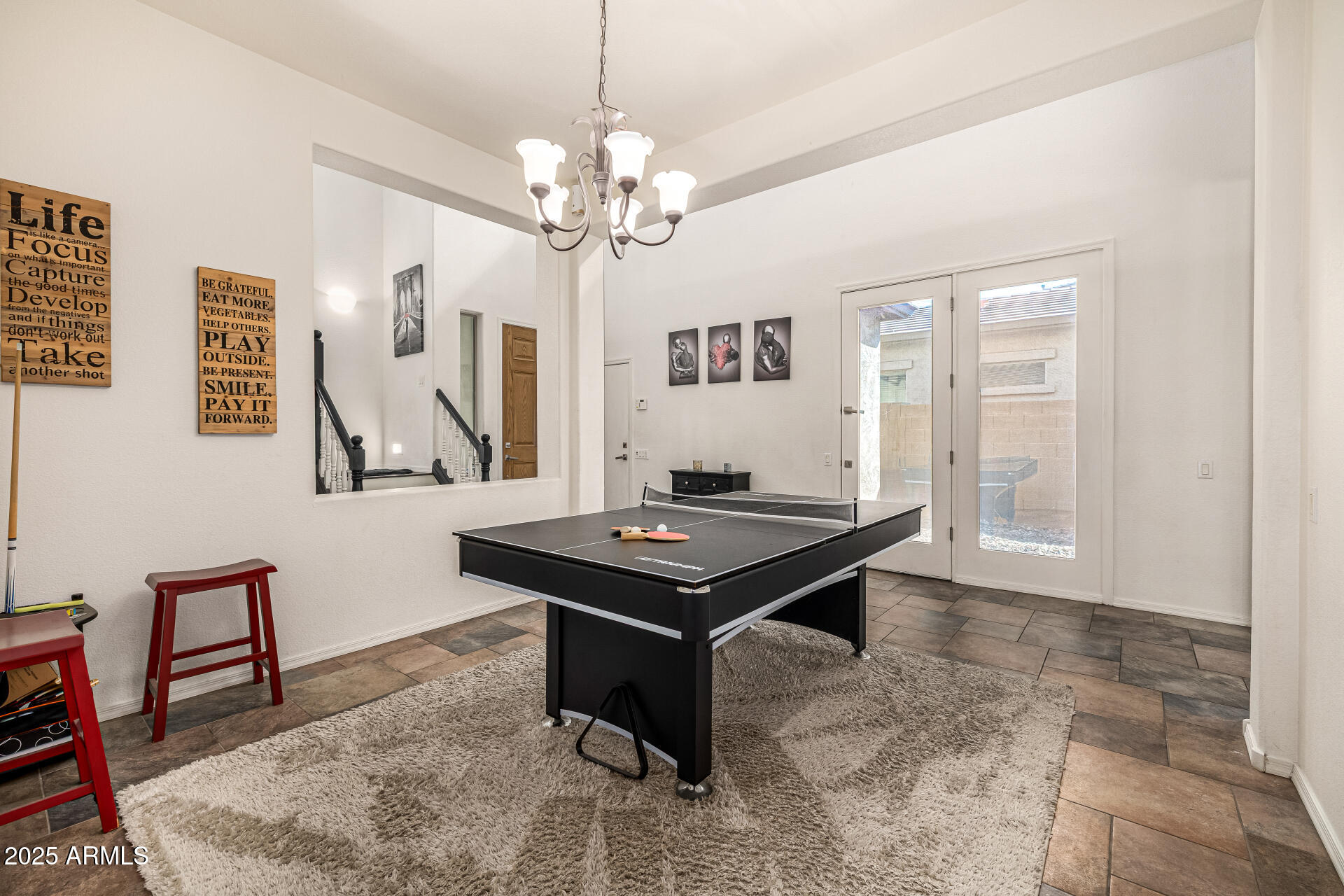 2026 North Rascon Loop Phoenix, AZ 85037 - Photo 7 of 38 a living room with a table chairs and a window