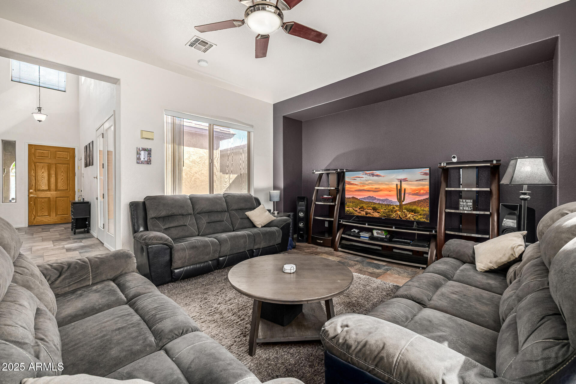 2026 North Rascon Loop Phoenix, AZ 85037 - Photo 9 of 38 a living room with furniture and a flat screen tv