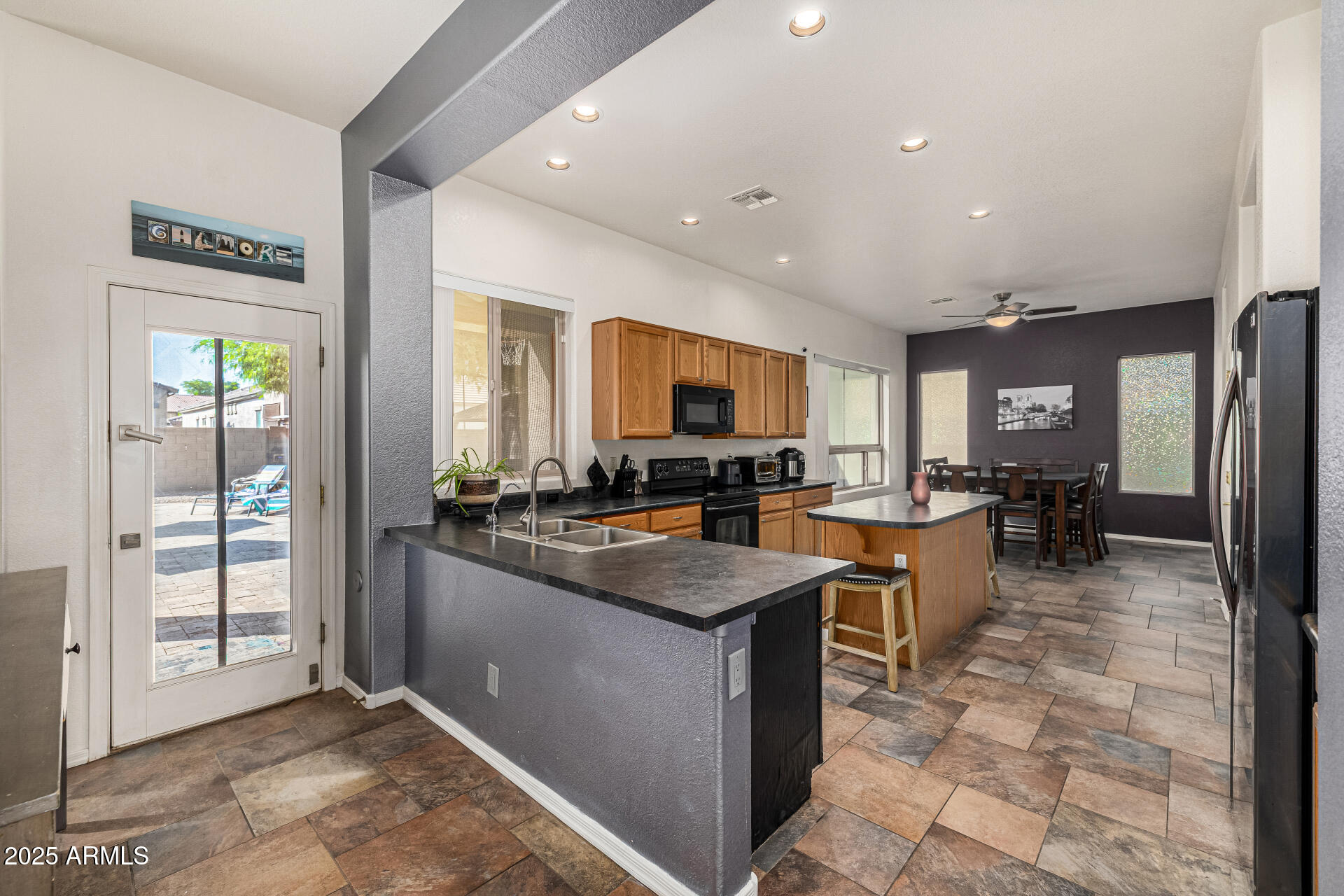 2026 North Rascon Loop Phoenix, AZ 85037 - Photo 10 of 38 a kitchen with lots of counter top space and stainless steel appliances