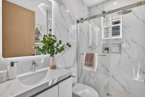 a bathroom with a sink toilet and shower