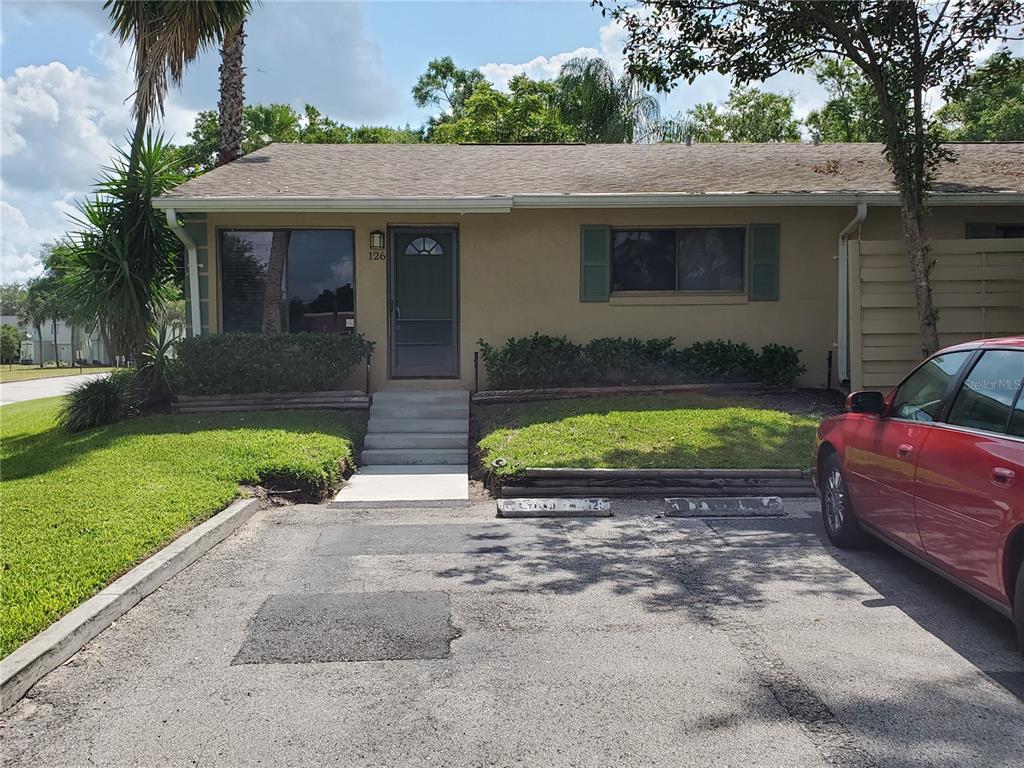 220 Cherokee Court, Unit 126 Altamonte Springs, FL 32701 - Photo 1 of 1 a view of a house with a yard plants and a patio