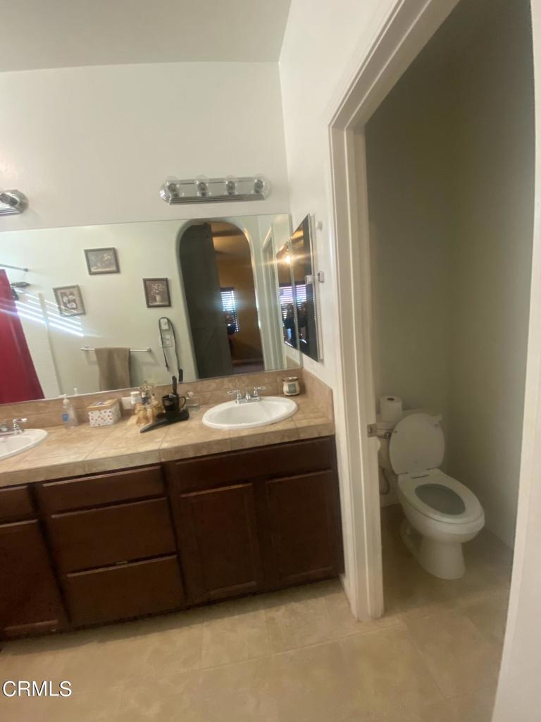 9116 Kellyann Street Bakersfield, CA 93313 - Photo 17 of 37 a bathroom with a sink and a mirror