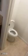 9116 Kellyann Street Bakersfield, CA 93313 - Photo 23 of 37 a white toilet sitting in a bathroom