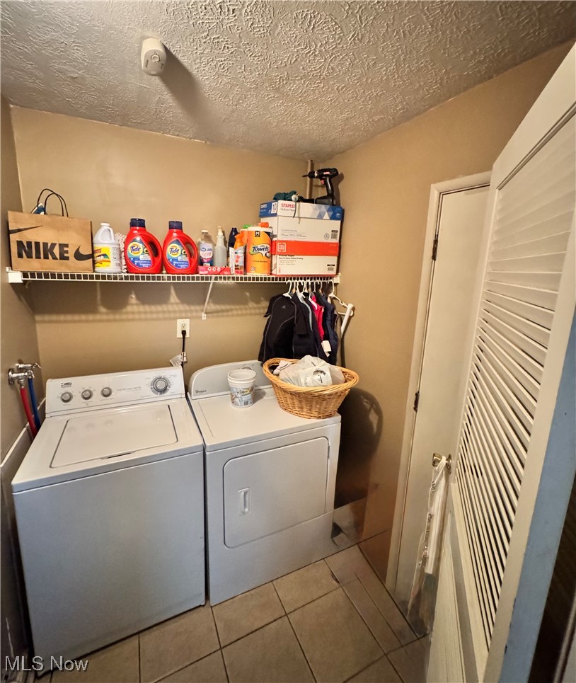 5945 Randy Road Bedford Heights, OH 44146 - Photo 7 of 13 Washroom with washer and dryer, tile patterned floors, and a textured ceiling