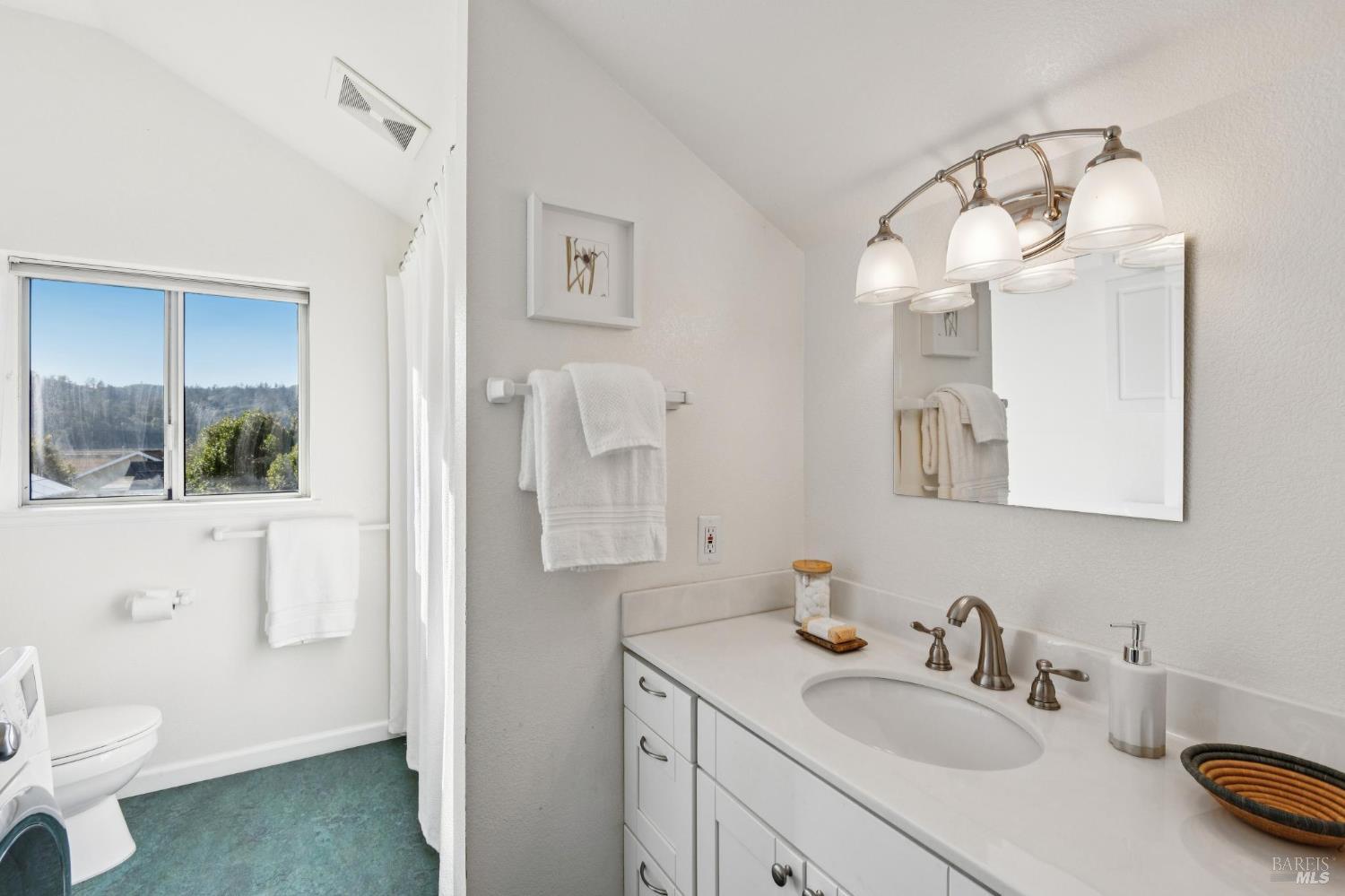 700 B Street Point Reyes Station, CA 94956 - Photo 13 of 26 a bathroom with a sink vanity granite toilet and a mirror