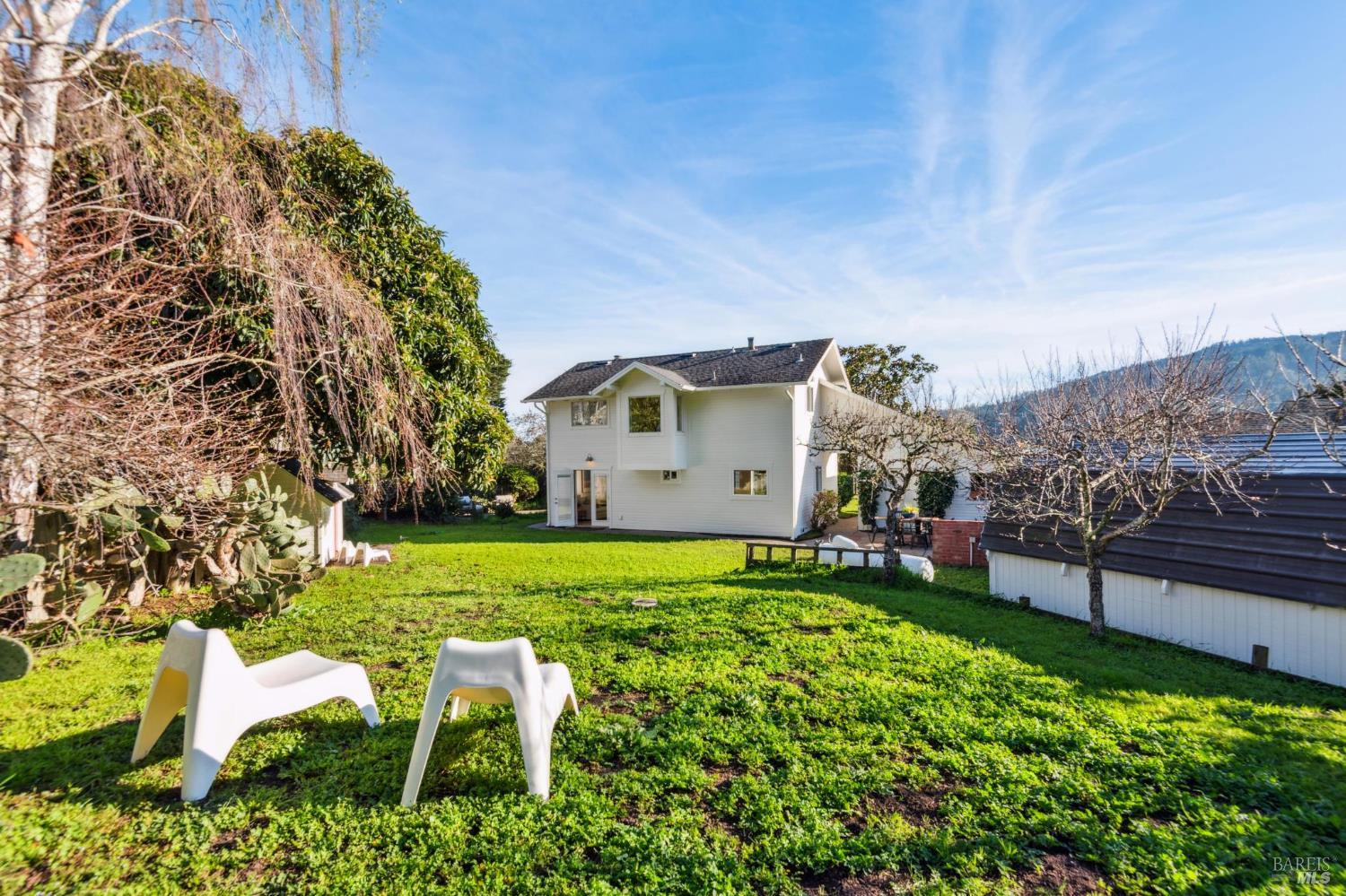 700 B Street Point Reyes Station, CA 94956 - Photo 14 of 26 a backyard of a house with table and chairs
