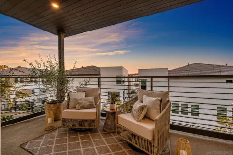 a roof deck with a dining table and chairs