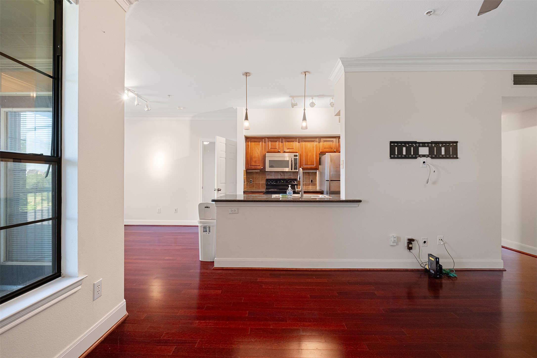 7701 Rialto Boulevard, Unit 637 Austin, TX 78735 - Photo 9 of 25 Rich hardwood floors flow through this open concept living space, anchored by a modern kitchen with a breakfast bar.