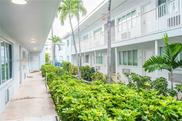 a view of a house with potted plants