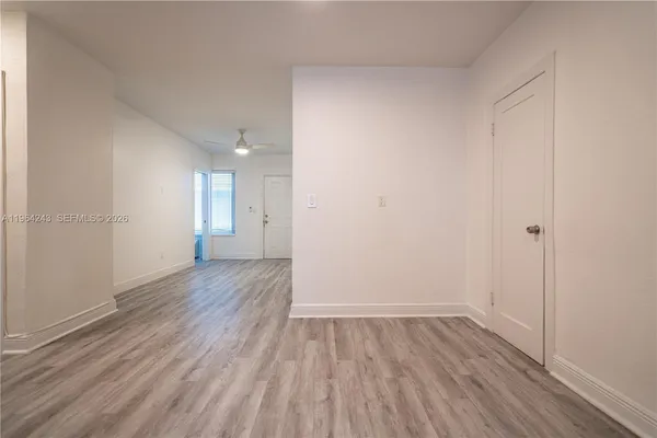 a view of a room with wooden floor and windows