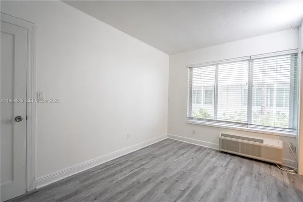 a view of a room with wooden floor and windows
