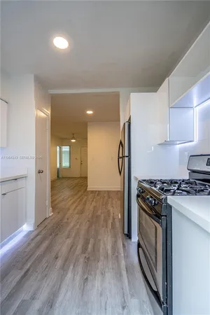 a kitchen with a stove and a refrigerator