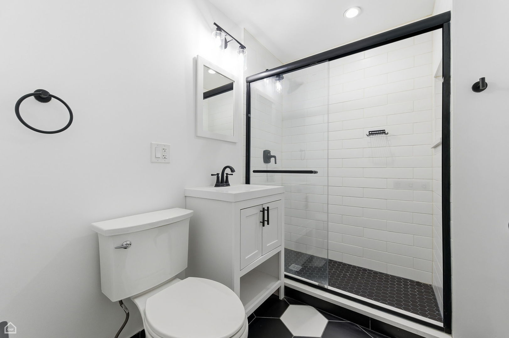 5250 West Grace Street, Unit 2 Chicago, IL 60641 - Photo 3 of 12 a bathroom with a toilet a sink and shower