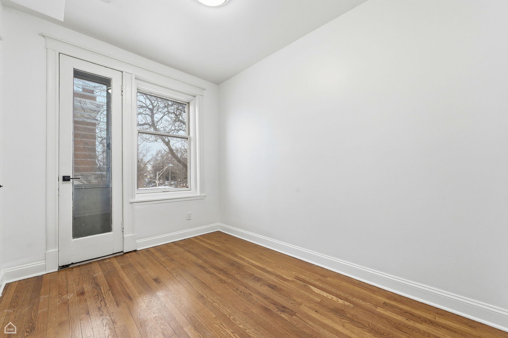 5250 West Grace Street, Unit 2 Chicago, IL 60641 - Photo 8 of 12 an empty room with a window