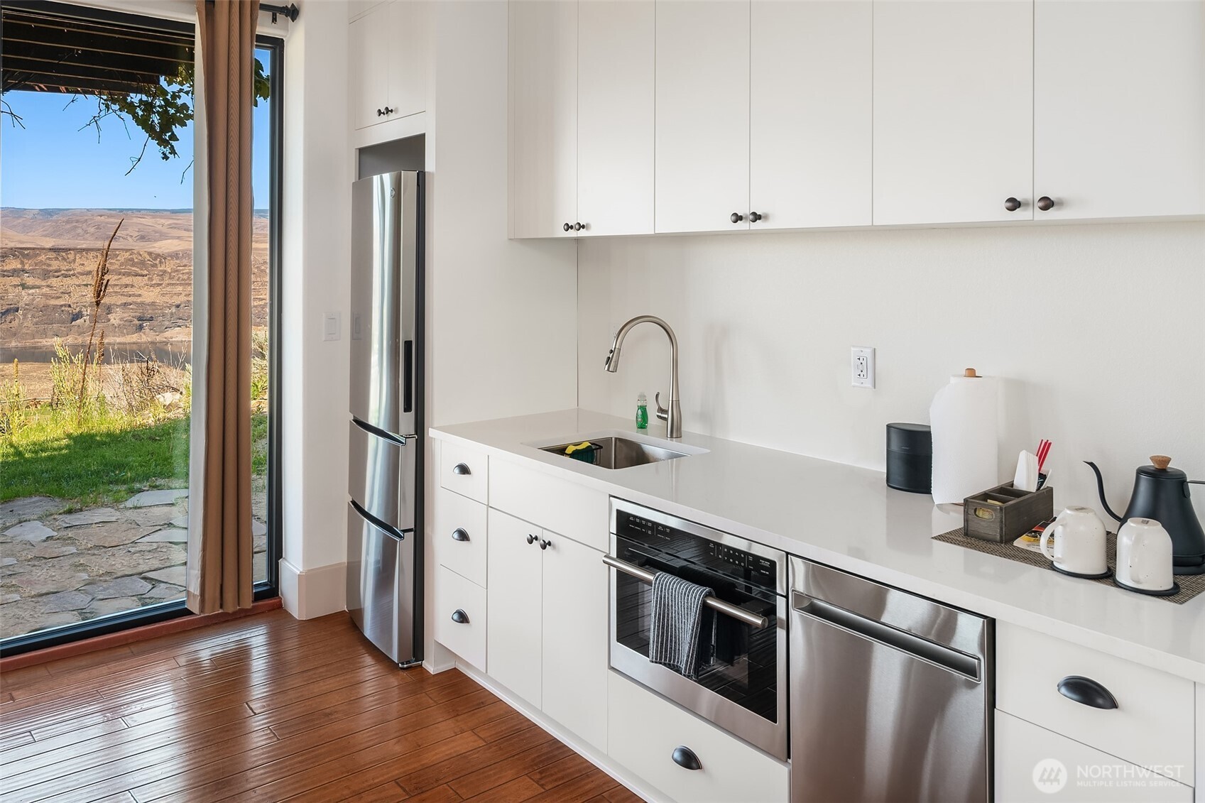 344 Silica Road Northwest, Unit 1 Quincy, WA 98848 - Photo 11 of 30 a kitchen with stainless steel appliances granite countertop a sink stove and refrigerator