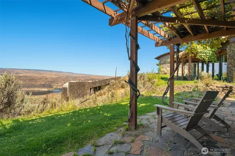 a view of a house with a yard and lake view