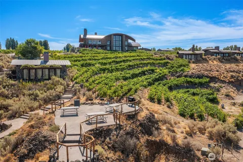 a living room with furniture a fireplace and a floor to ceiling window