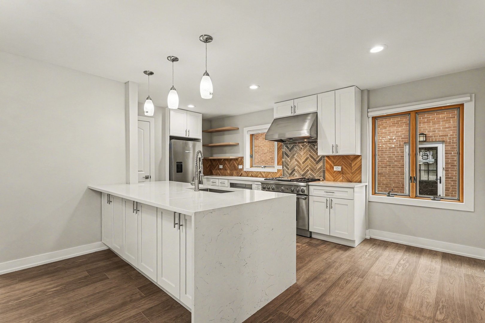 538 North Broadway Avenue Park Ridge, IL 60068 - Photo 2 of 34 a kitchen with stainless steel appliances granite countertop a stove a sink a refrigerator and white cabinets with wooden floor