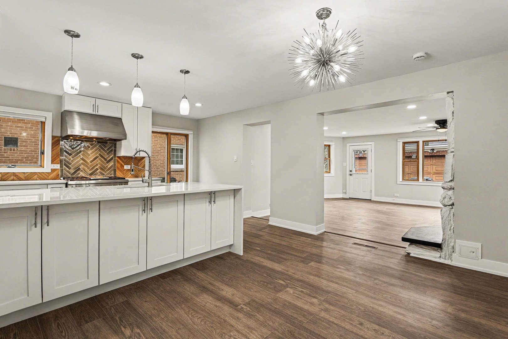 538 North Broadway Avenue Park Ridge, IL 60068 - Photo 3 of 34 a open kitchen with kitchen island a sink dishwasher a stove and a refrigerator with wooden floor