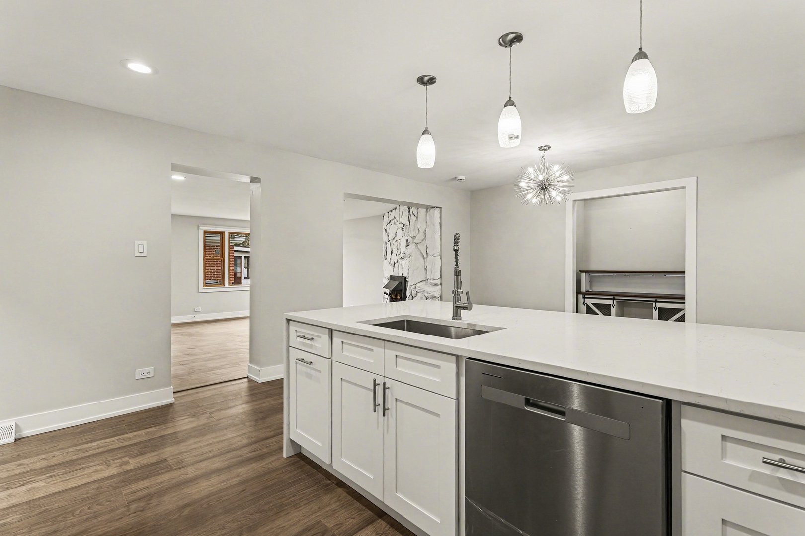 538 North Broadway Avenue Park Ridge, IL 60068 - Photo 5 of 34 a kitchen with a sink dishwasher a stove and white cabinets with wooden floor