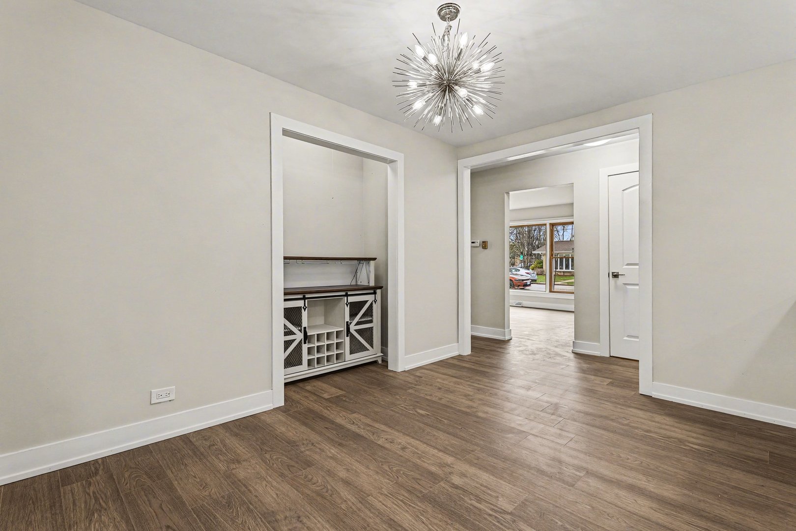 538 North Broadway Avenue Park Ridge, IL 60068 - Photo 7 of 34 an empty room with wooden floor chandelier fan and windows