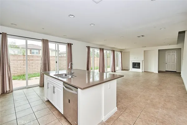 a large white kitchen with a large window