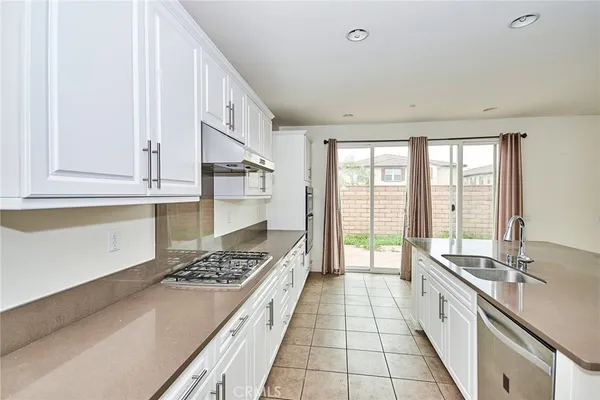 a large white kitchen with a large window