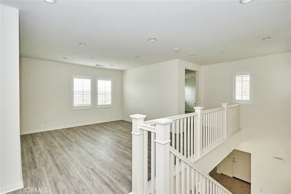 a view of livingroom with stairs and wooden floor